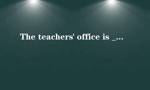 The teachers' office is _____my classroom.